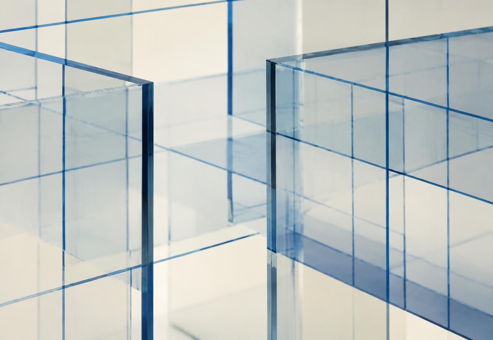 Transparent panels crossed by a blue technical grid, suggesting layered system design